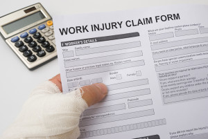 Hurted Hand Holding A Work Injury Claim Form